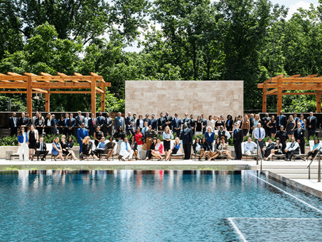 Post Brothers team in front of a pool and some pergolas